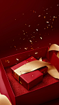 A red gift box with gold and glitter, in the style of jeeyoung lee, trompe-l'oeil folds, conceptual portraiture, dark red and light beige, scattered composition, conceptual installation, studyblr
