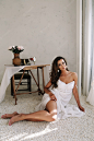 Photo portrait of a young beautiful woman. boudoir.  beautiful girl with long dark hair dressed in white dress
