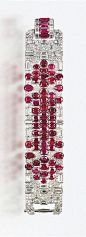 A SUPERB ART DECO RUBY AND DIAMOND BRACELET Of geometric motif, designed as an articulated pavé-set diamond wide band, with baguette-cut diamond details, decorated with a series of oval-shaped rubies, to the rectangular-cut ruby and diamond clasp, circa 1
