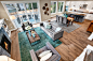 Example of a classic open concept medium tone wood floor living room design in Seattle with beige walls, a standard fireplace, a stone fireplace and a wall-mounted tv