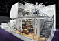 This may contain: a store with stairs and furniture inside of it's display area at an event