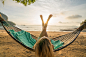 Young woman relaxing on hammock by the beach, sunrise- Thailand