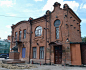 an old brick building with a statue in front