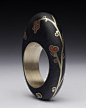 Andrea Williams "Kebyar Blossom Ring", inlaid gold and Ventian glass into beach stone.  Finalist for the 2011 Saul Bell Design award.