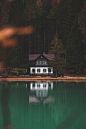 white and black painted house near body of water