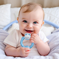 dazspirit_Cute_baby_lying_on_bed_with_dental_ring_in_hand_83383044-a9b4-41a2-b2fb-f8ef4238c02d