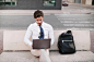 young-man-sitting-bench-working-laptop_23-2147860922