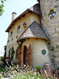 a very cute looking house in the grass