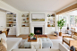 Huge beach style open concept and formal medium tone wood floor living room photo in New York with white walls, a standard fireplace and a stone fireplace