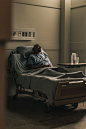 a male hospital patient rests head on pillows in bed