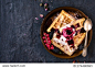 Traditional Belgian waffles with ice cream and berry fruit sauce in the plate,selective focus and blank space