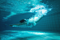 athletic-swimmer-smiling-camera-underwater-swimming-pool-leisure-centre