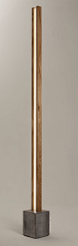 The Lubois : a floor lamp with a clear LED light strip inside a vertical structure in wood: 