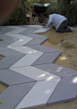 2 tones of gray chevron shaped pavers installed.