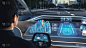 未来概念:时尚的商人坐在自动驾驶零排放电动汽车中，在增强现实仪表板上的交互式3D导航应用程序上设置位
