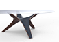 RAY - DINING TABLE : RAY, as the name evokes, takes its inspiration from the flattened and lozenge-shaped fish.The table is composed by a wood sculpture sheathed in shagreen hide.The transparent glass top brings out the design and work of these two noble 