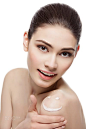 Girl with cream smiley face on shoulder