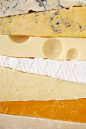 This may contain: different types of cheese arranged on top of each other