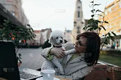 在城市咖啡馆酒吧里带着贵宾犬的老妇人