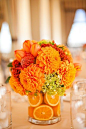 I love these orange zinnias. I'm thinking either pair them with some white hydrangeas or peonies. And for the tables- painting mason jars with an aqua color to tie in all our wedding colors!: 