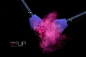 Color Explosion with Makeup Brushes Applying Powder. Isolated on black stock photo