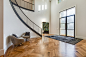 Entryway - mid-sized transitional medium tone wood floor and brown floor entryway idea with white walls and a glass front door