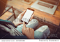 girl using smartphone in cafe. smartphone white screen. hand holding smartphone. black color smartphone on vintage tone.