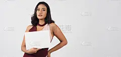 亚洲美丽的年轻女子手持空白纸。白色背景的画室肖像。空白的文字。她有黝黑的皮肤。