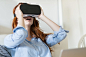 Young woman using VR headsets