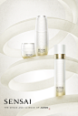 This may contain: an advertisement for the skin care brand sensai, featuring two white containers with gold rims