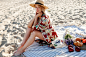 Free photo pretty blond woman in straw hat sitting on tropical beach, enjoying holidays near ocean.