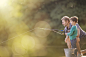 Father and son fishing in lake by Caia Images on 500px