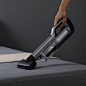 This may contain: a person using a vacuum to clean a bed