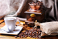 Composition with a cup of coffee, beans and coffee grinder