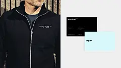 一件拉链夹克，上面印有白色字体的 Sora Fuel 标志和一只青色小鸟，还有一张一面为黑色、另一面为青色的简约名片。