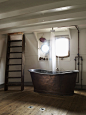 Basement bathroom with a rustic tub. | home: bathe