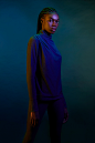 Coura Sasha from SLU Agency : African American model in dark moody studio setting. Colored gels are used for added drama and atmosphere. Fitness apparel is highlighted. 