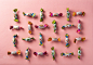 Assorted candies over pink paper background by Gabor Havasi on 500px