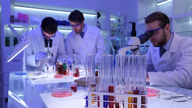videoblocks-team-of-lab-medical-researchers-working-with-microscope-in ...
