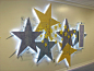 Comanche County Memorial Hospital - Starlight Unit : Striking laminate stars are the backdrop for this lighted children’s display. Six panels of glass are used to showcase different features of the display. The first panel has a beautifully etched narrati