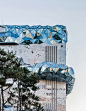 oma shapes gwanggyo galleria department store as a sculpted stone textured with mosaic stone and multifaceted glass facade