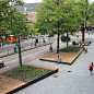 urban podium with large hardwood seating area and greenery