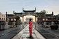 Asian young woman in old traditional Chinese dresses in Hutong v