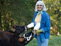 Caucasian woman feeding bottles to calves by Gable Denims on 500px