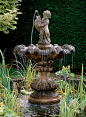 water fountain with a sculpture for luxurious backyard ideas