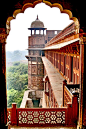 Agra Fort, is a monument, a UNESCO World Heritage site  in Agra, Uttar Pradesh, India. It is about 2.5 km northwest of its more famous sister monument, the Taj Mahal. The fort can be more accurately described as a walled city.   (built before 1080).  Red 