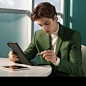 yichao777_dark_green_casual_suit__eyes_looking_at_the_pen_in_ha_5aaef969-fa8f-4feb-be17-5cc42679facf