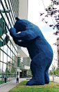 Sculpture of a big blue bear peeking through the windows of the Denver Convention Center.    I See What You Mean, 2005, Lawrence Argent, Composite materials