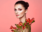 Portrait of beautiful young woman with Alstroemeria flowers