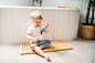 A toddler boy with a toothbrush sitting on the floor in the bathroom at home. by Jozef Polc on 500px